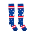 Flat lay of two blue knee-high socks with white stars and red and white stripes against a black background.