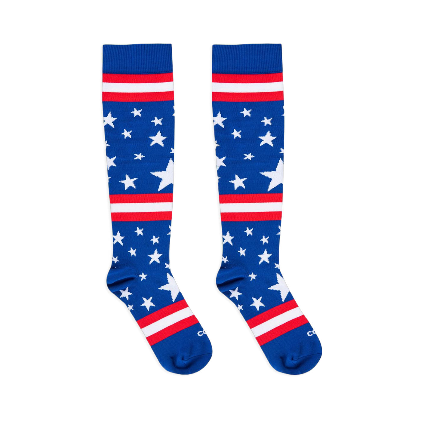 Flat lay of two blue knee-high socks with white stars and red and white stripes against a black background.
