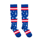 Flat lay of two blue knee-high socks with white stars and red and white stripes against a black background.