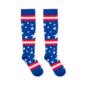 Flat lay of two blue knee-high socks with white stars and red and white stripes against a black background.