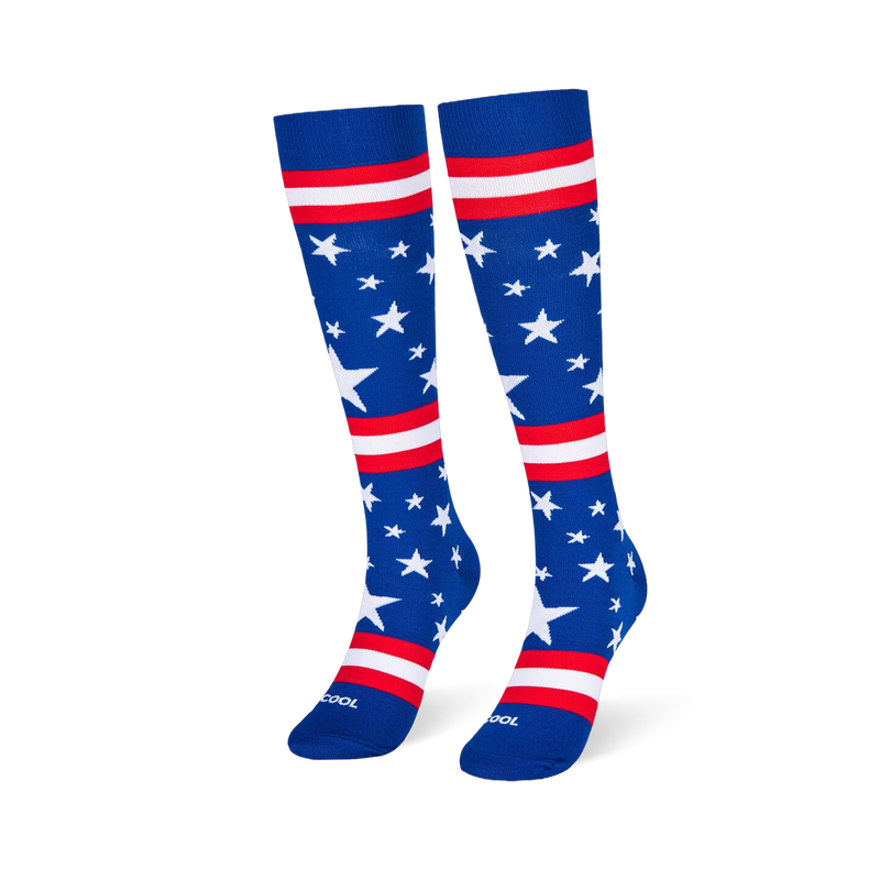 Blue knee-high socks standing upright, featuring white stars and red and white stripes across the leg and foot area.