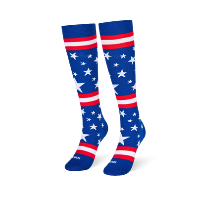 Blue knee-high socks standing upright, featuring white stars and red and white stripes across the leg and foot area.