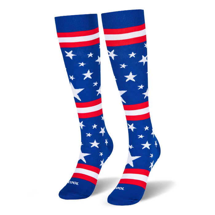 Blue knee-high socks standing upright, featuring white stars and red and white stripes across the leg and foot area.