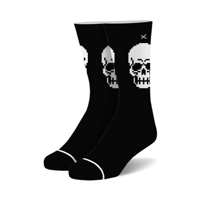 black crew socks with a pixelated skull design in white with a black outline. 