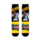 Flat lay of Elvis crew socks showing the King in his white jumpsuit on a black leg, with a bright yellow retro foot design.