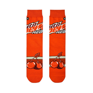 Flat lay of two orange socks side-by-side, displaying the Mtn Dew logo on the top half and cherry graphics on the bottom.