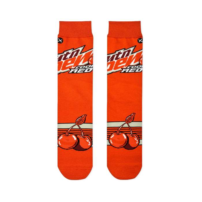 Flat lay of two orange socks side-by-side, displaying the Mtn Dew logo on the top half and cherry graphics on the bottom.