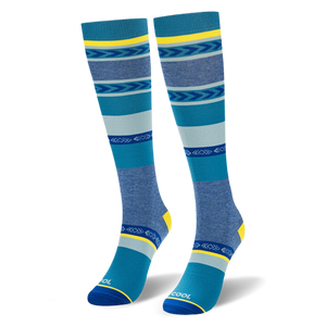 Angled studio shot of blue geometric striped knee-high socks highlighting the bright yellow heel and COOL toe text.