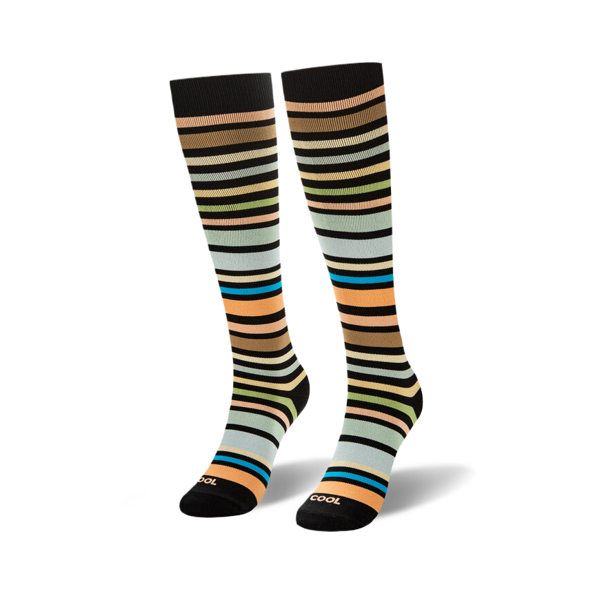 Knee-high socks featuring horizontal stripes in brown, peach, green, light blue, and bright teal on a black background.