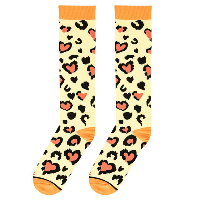 Lifestyle shot showing the Leopard Heart Medium socks on a model's legs. 