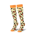 Pair of knee-high cream socks with black and coral heart-shaped leopard spots displayed on a white background.