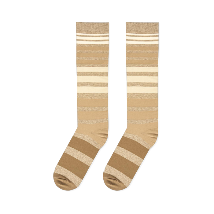 Flat lay presentation of tan, brown, and cream striped tall socks showing the full length and heel construction.