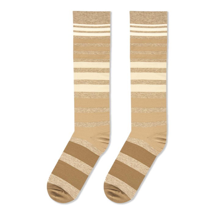 Flat lay presentation of tan, brown, and cream striped tall socks showing the full length and heel construction.