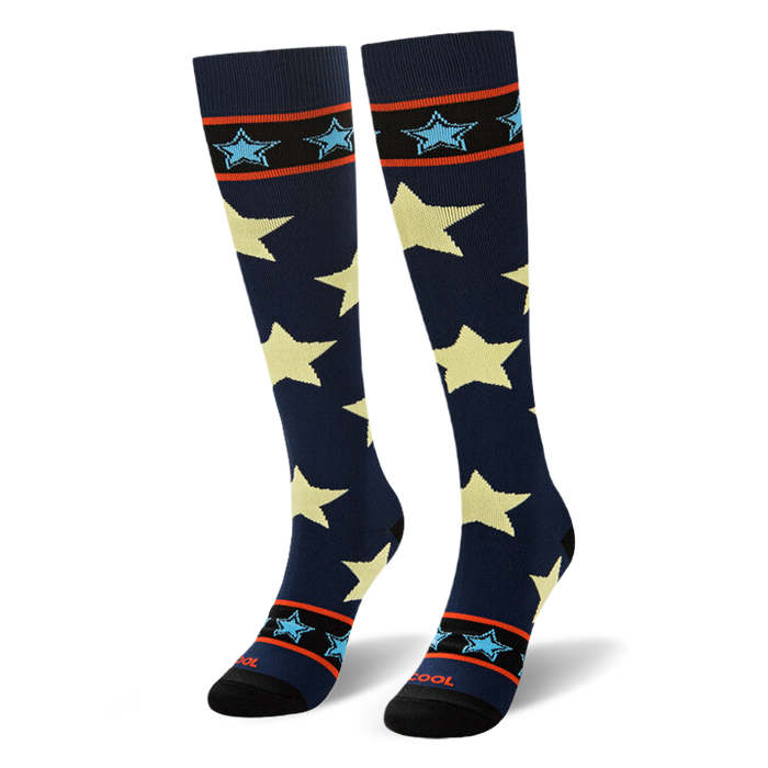 Angled view of navy socks standing upright to show the striped band near the black toe with the word COOL in red.