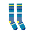 Flat lay of two blue and yellow striped knee-high socks positioned parallel to each other against a dark background.