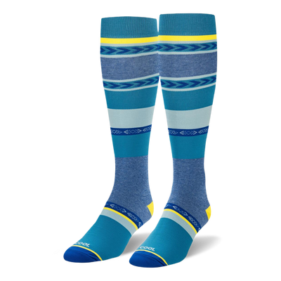 Knee-high socks featuring wide teal, navy, and heather blue stripes mixed with geometric arrow patterns and yellow accents.