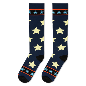 Flat lay of tall navy socks displaying large pale stars alongside top cuffs with bright borders and light blue stars.
