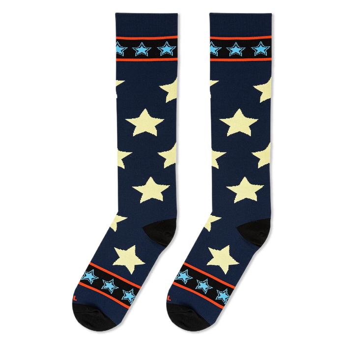 Flat lay of tall navy socks displaying large pale stars alongside top cuffs with bright borders and light blue stars.
