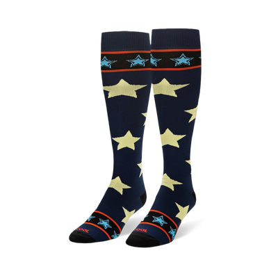 Tall navy blue socks showing large pale yellow stars and striped black cuffs with small light blue stars.