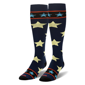 Tall navy blue socks showing large pale yellow stars and striped black cuffs with small light blue stars.