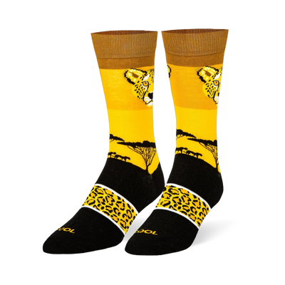 Yellow crew socks with a cheetah face, black savanna tree silhouette, and a black foot featuring a spotted yellow band.