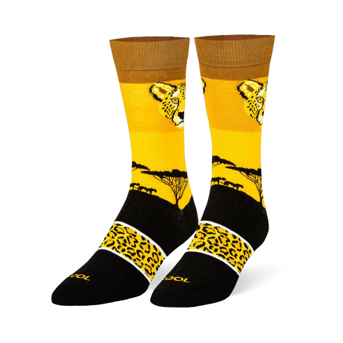 Yellow crew socks with a cheetah face, black savanna tree silhouette, and a black foot featuring a spotted yellow band.