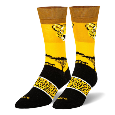 Yellow crew socks with a cheetah face, black savanna tree silhouette, and a black foot featuring a spotted yellow band.