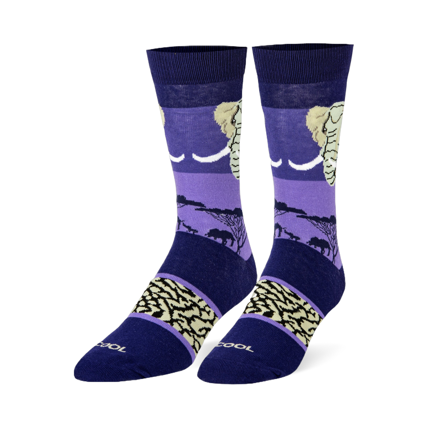 Dark blue and purple crew socks featuring an elephant head, black savanna silhouettes, and a beige wrinkled skin pattern.