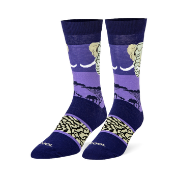 Dark blue and purple crew socks featuring an elephant head, black savanna silhouettes, and a beige wrinkled skin pattern.