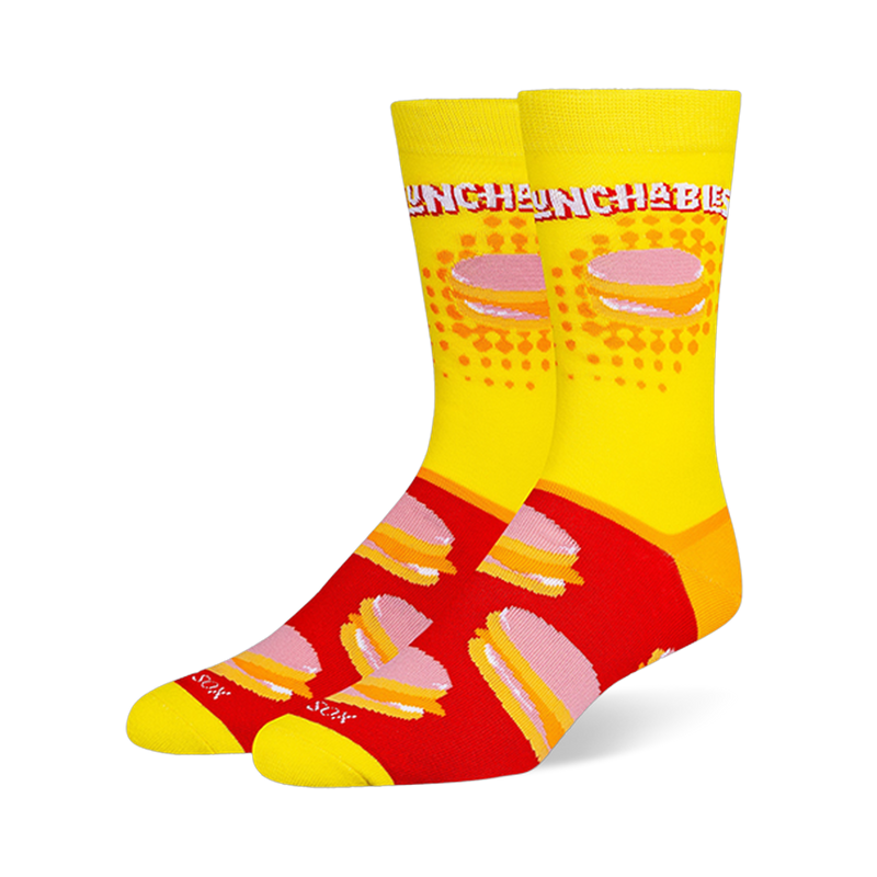 Crew socks featuring a yellow leg with the Lunchables logo and a red foot with a repeating pattern of stacked cracker snacks.