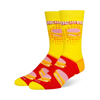 Crew socks featuring a yellow leg with the Lunchables logo and a red foot with a repeating pattern of stacked cracker snacks.