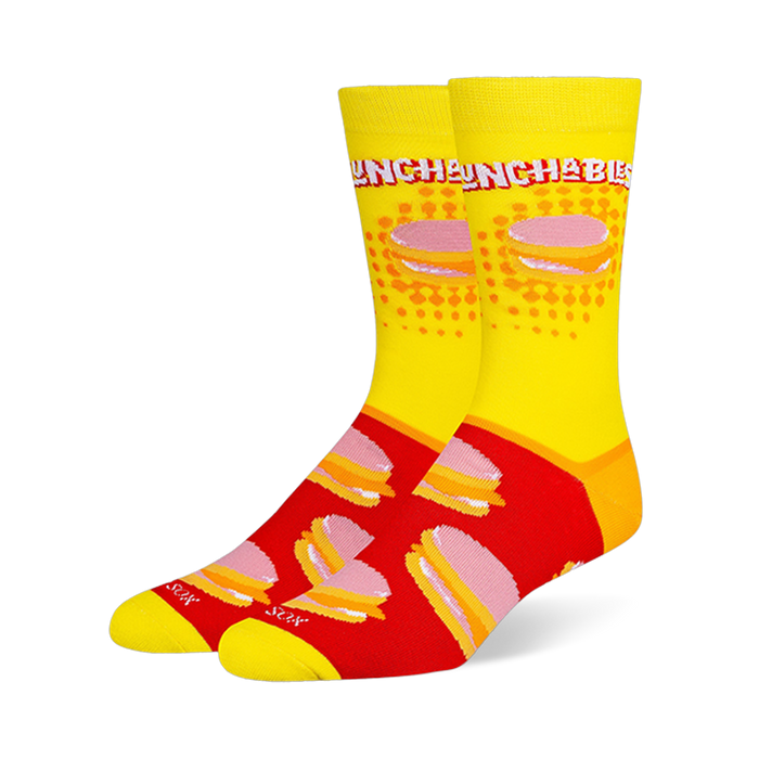 Crew socks featuring a yellow leg with the Lunchables logo and a red foot with a repeating pattern of stacked cracker snacks.