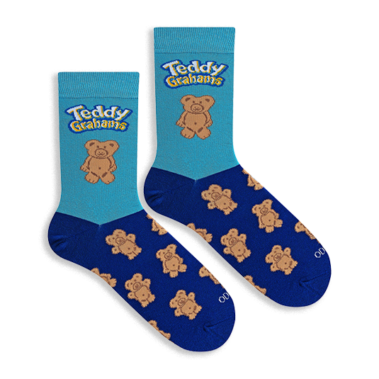 Flat lay of two crew socks. Light blue top with Teddy Grahams logo and one large bear. Navy blue foot with bear pattern.