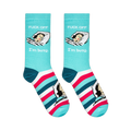 Flat lay of aqua crew socks showing a vintage sleeping woman, text reading FUCK OFF I'm busy, and bold striped feet.