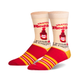 A pair of cream crew socks with red and yellow stripes. The socks feature a repeating image of Frank's RedHot sauce bottle and the phrase 'I put that on everything'.