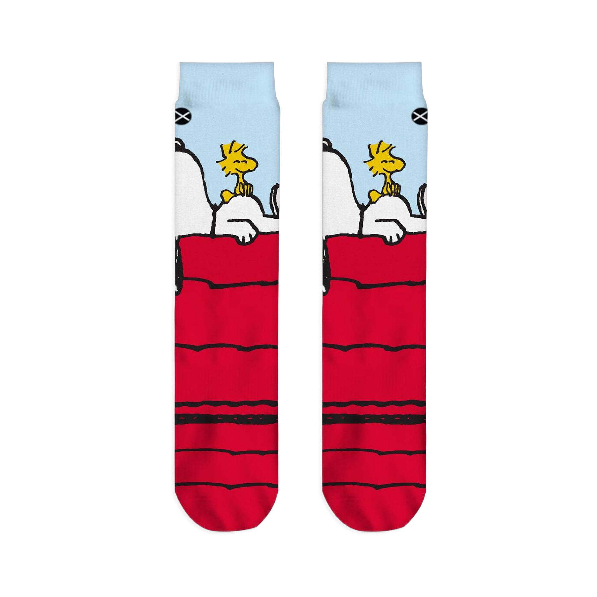 Flat lay of two crew socks side-by-side displaying Snoopy resting on a red doghouse with Woodstock under a blue sky.
