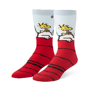Crew socks featuring Snoopy sleeping on a red doghouse roof with Woodstock sitting on his belly against a light blue sky.