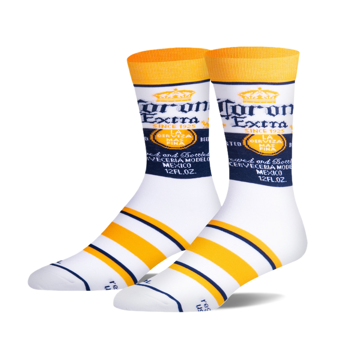 Pair of white crew socks with Corona Extra logo and yellow and navy blue stripes. 