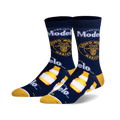 Pair of crew socks in navy blue, featuring Modelo beer bottle and logo graphics in yellow and white.