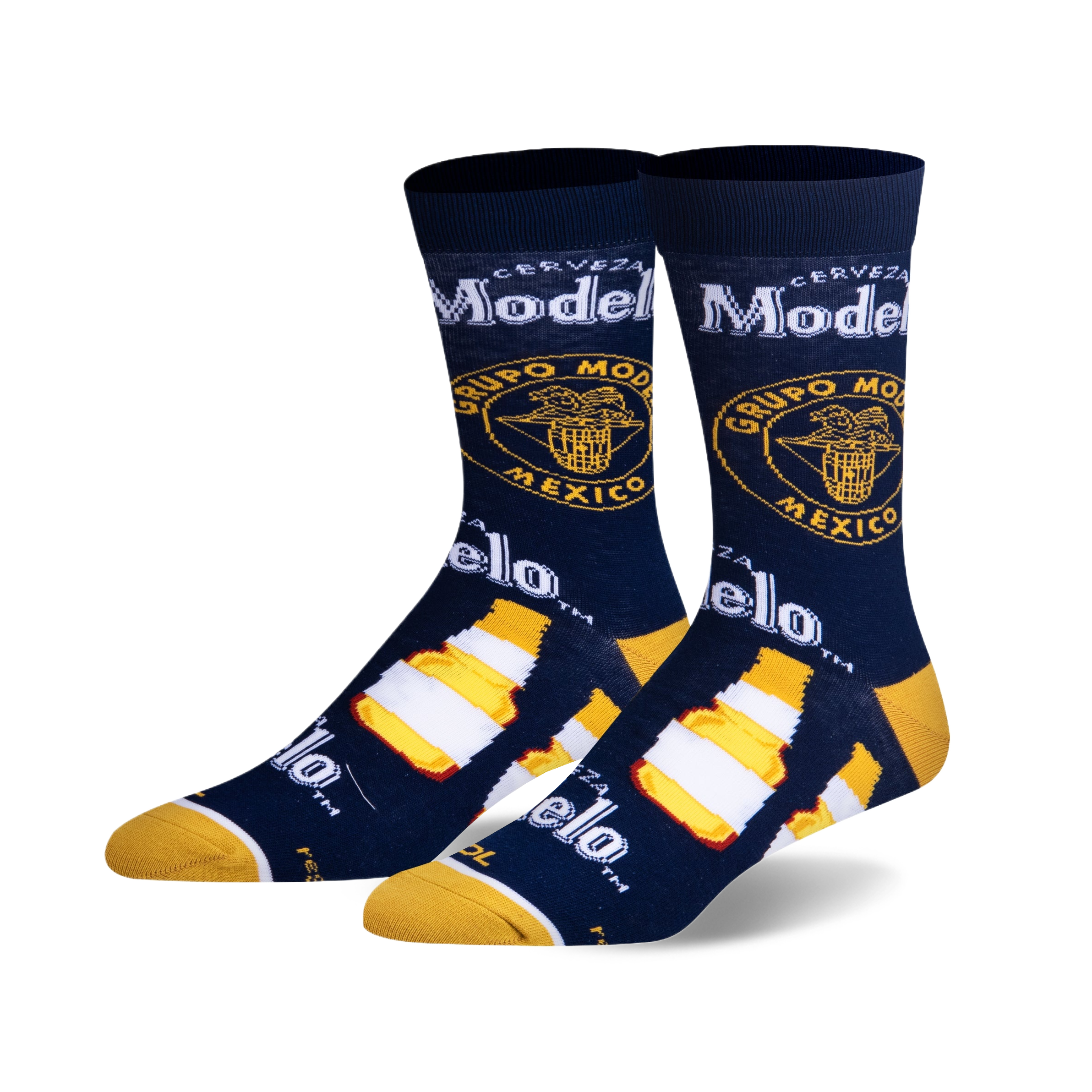 Pair of crew socks in navy blue, featuring Modelo beer bottle and logo graphics in yellow and white.