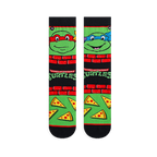 Flat lay of two TMNT socks showing Raphael in red on the left and Leonardo in blue on the right, with pizza slices below.