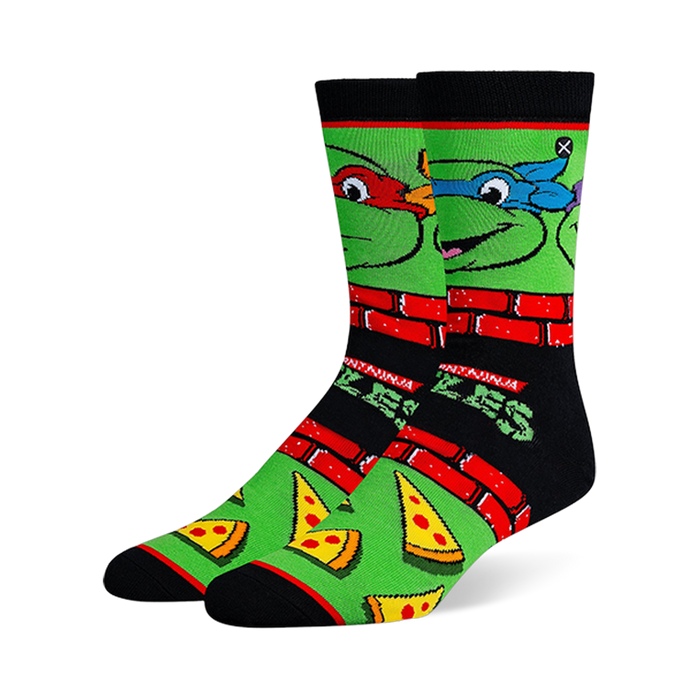 Black and green crew socks with Teenage Mutant Ninja Turtle faces, red brick borders, classic logos, and pizza slices.