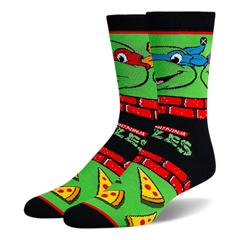 Black and green crew socks with Teenage Mutant Ninja Turtle faces, red brick borders, classic logos, and pizza slices.