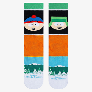 Close-up product shot highlighting the South Park characters, text, and snowy mountain landscape on the socks.