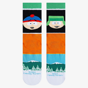 Close-up product shot highlighting the South Park characters, text, and snowy mountain landscape on the socks.