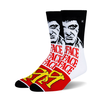 Pair of crew socks with a black and white Tony Montana portrait, repeating red "FACE" text, and a yellow TM logo. Black, white, red, yellow.