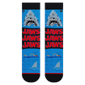 Flatlay showcasing a pair of Jaws Mash Up crew socks; highlighting the sock's design details.