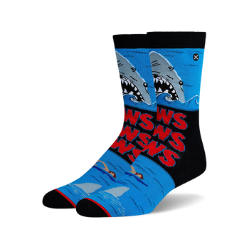 Blue crew socks with a Jaws movie design: gray sharks, red "JAWS" text, swimmers, and black accents.