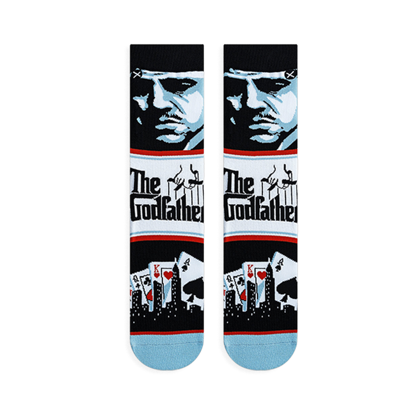 Flat lay of Godfather crew socks displaying a blue character portrait, The Godfather logo, and playing cards with a skyline.