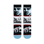 Flat lay of Godfather crew socks displaying a blue character portrait, The Godfather logo, and playing cards with a skyline.